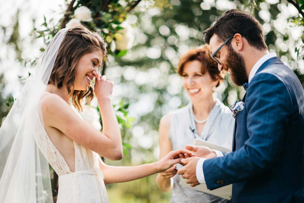 Zoe tears up while she and Daniel exchange rings at their wedding to Daniel at Woodinville Lavender Farm, Washington, summer 2016