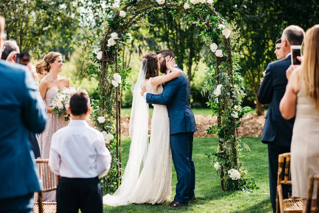Zoe and Daniel share their first kiss as husband and wife at Woodinville Lavender Farm, Washington, summer 2016