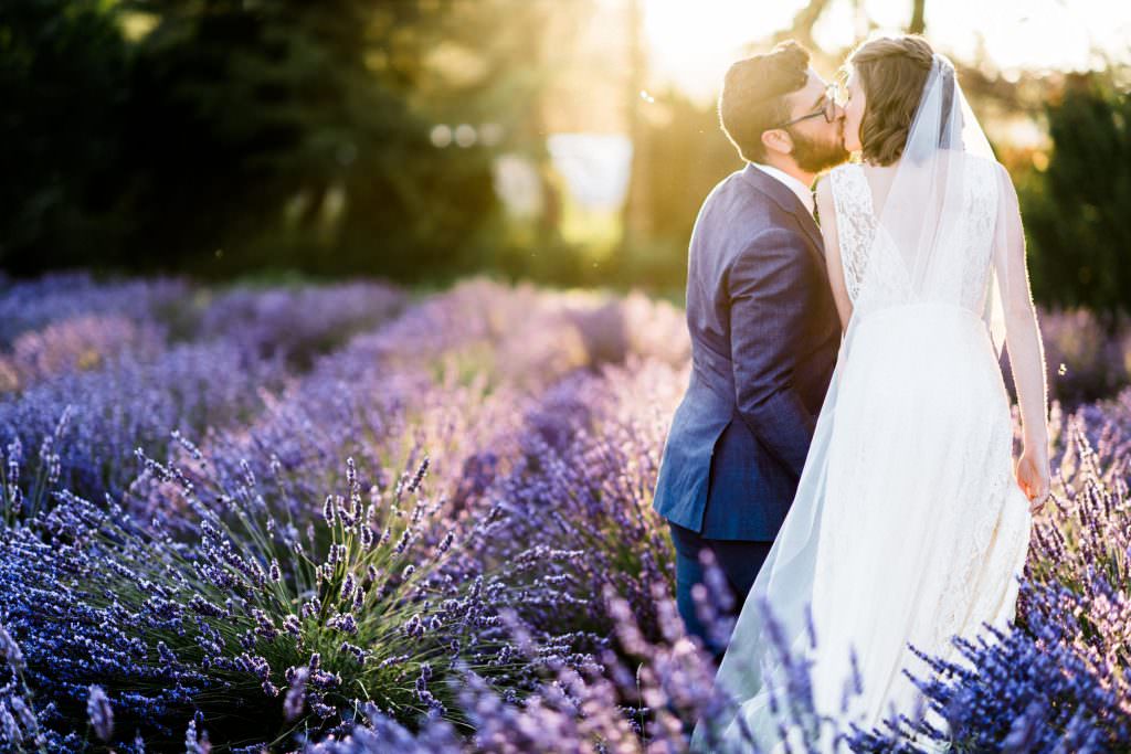 Zoe and Daniel walk through the lavender fields of Zoe and Daniel walk down the aisle at their wedding at Zoe and Daniel share their first kiss as husband and wife at Woodinville Lavender Farm, Washington, summer 2016