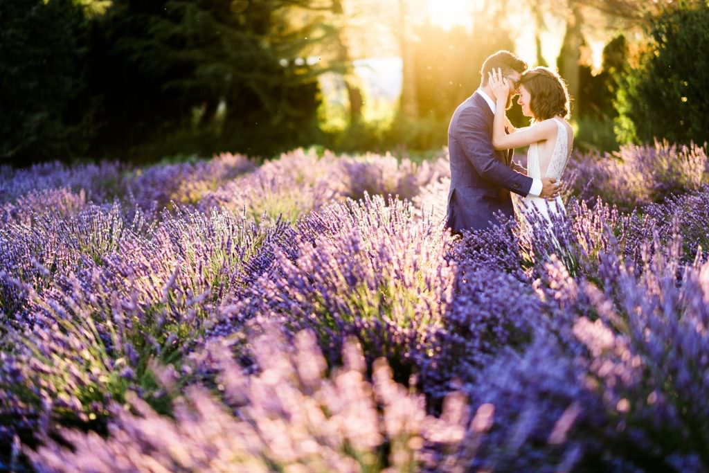 Zoe and Daniel embrace and share a quiet moment together at their wedding at Zoe and Daniel walk through the lavender fields of Zoe and Daniel walk down the aisle at their wedding at Zoe and Daniel share their first kiss as husband and wife at Woodinville Lavender Farm, Washington, summer 2016