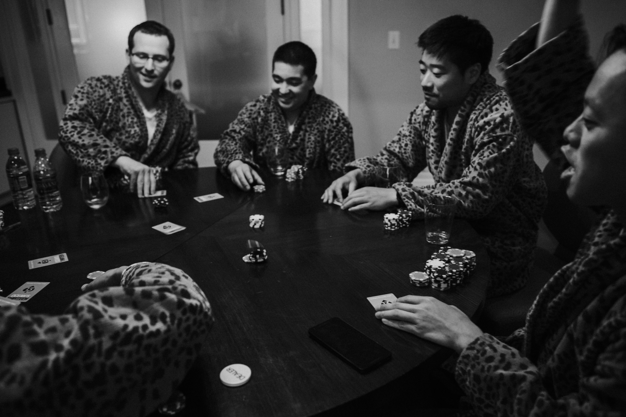 Jeremy and his groomsmen play poker before getting ready at the Alexis Hotel, Seattle, WA, for Jeremy and Amy's wedding.