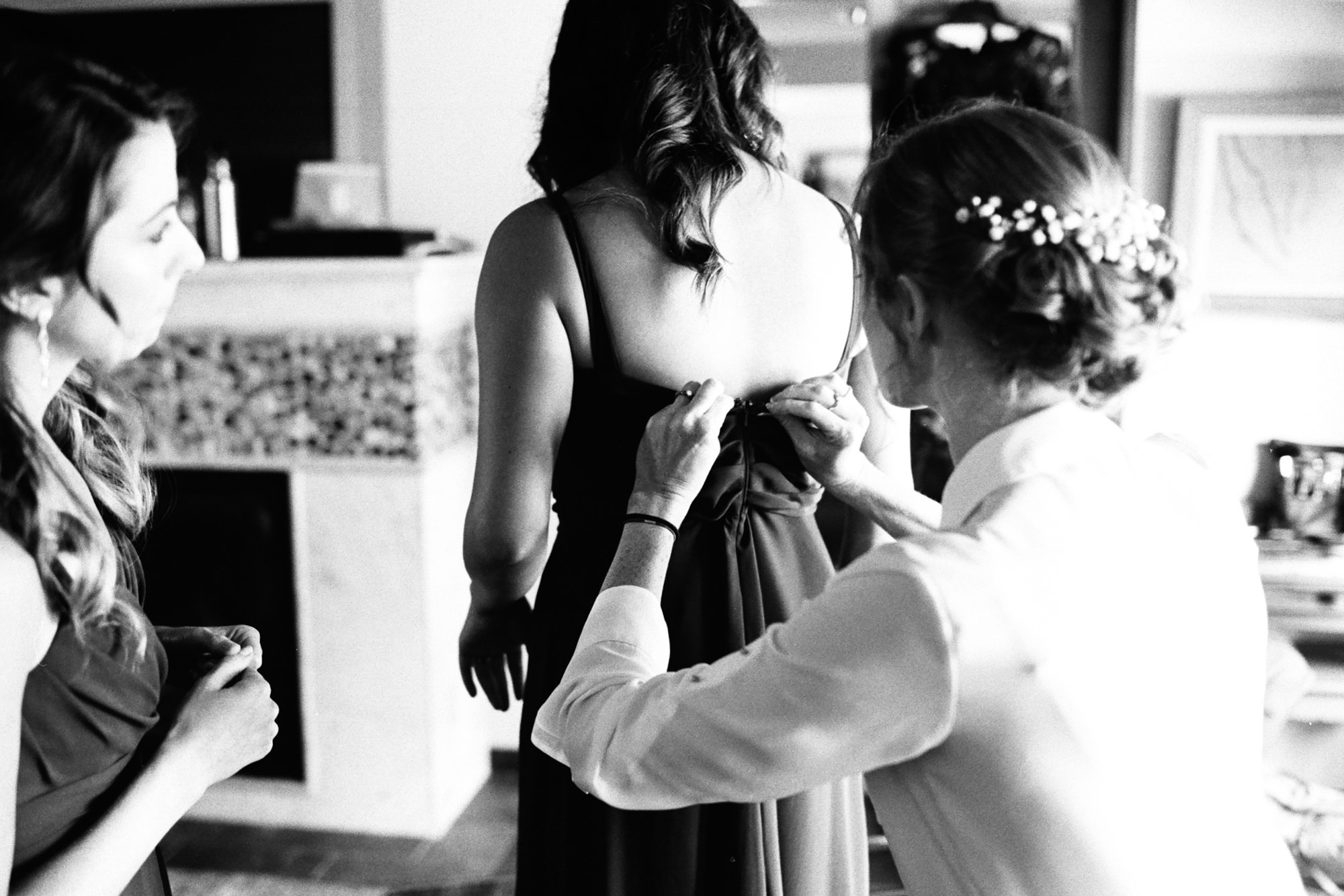 Katherine helping her bridesmaids get ready at Kingston House, a wedding venue in Kingston, WA.