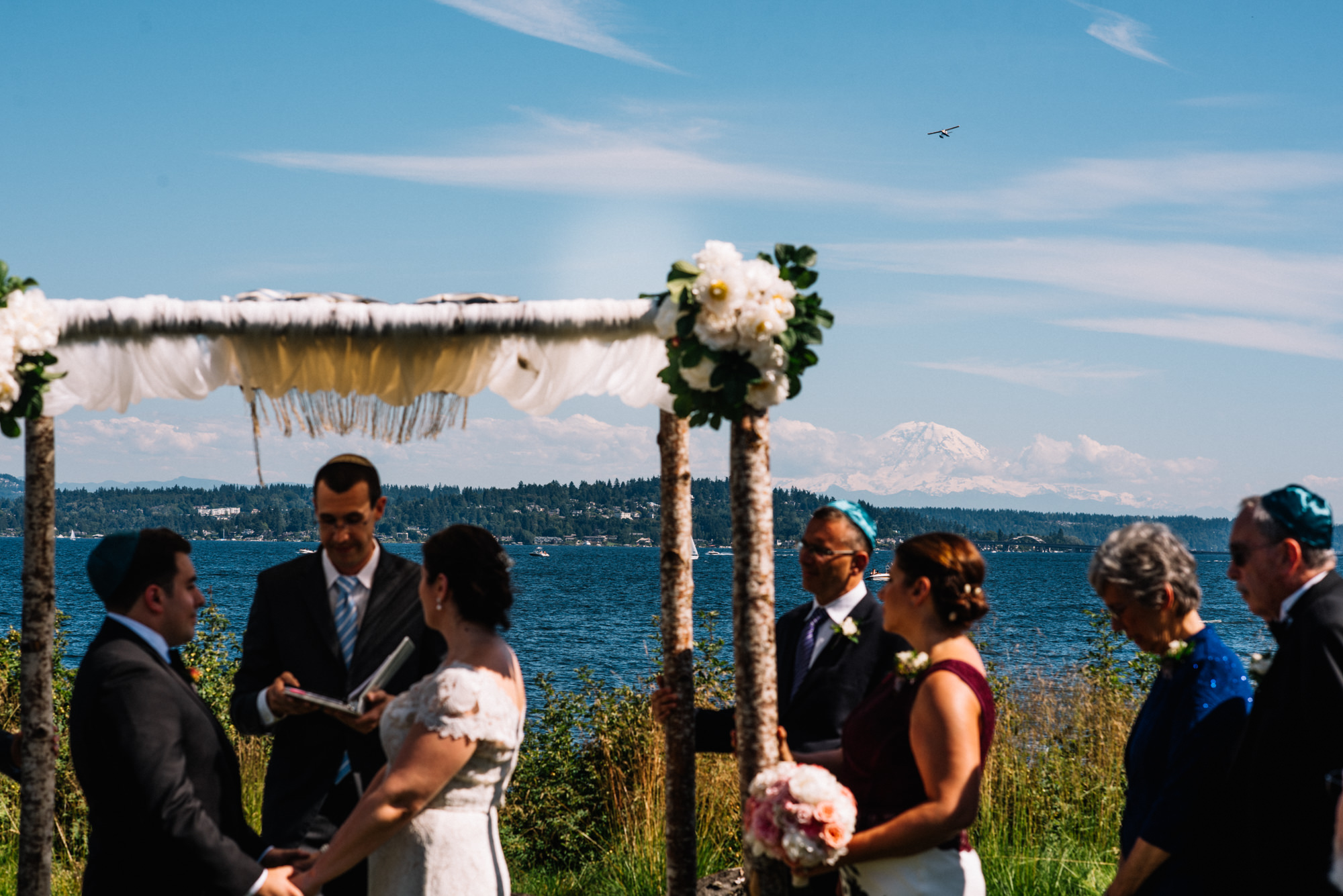 Mount Rainier is clear in the distance on this beautiful summer day on the Puget Sound. Joelle and Ryan were married at the Seattle Tennis Club, a wedding venue and sports club in Seattle, WA. Photo by Seattle Wedding Photographers Jennifer Tai Photo Artistry.