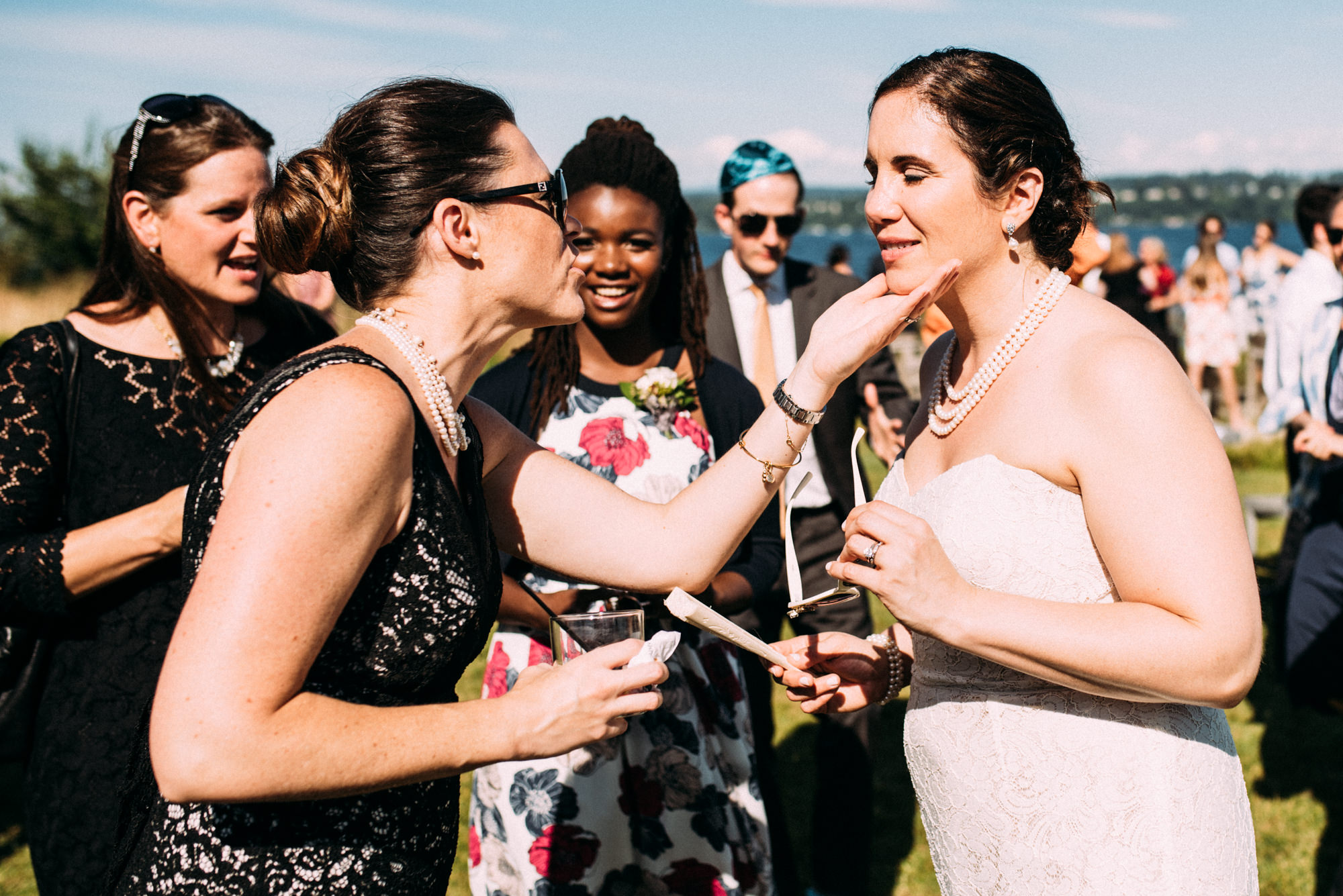 Guests and family greet the newlyweds at their cocktail reception at the Seattle Tennis Club. Summer 2016. Photo by Seattle Wedding Photographers Jennifer Tai Photo Artistry.