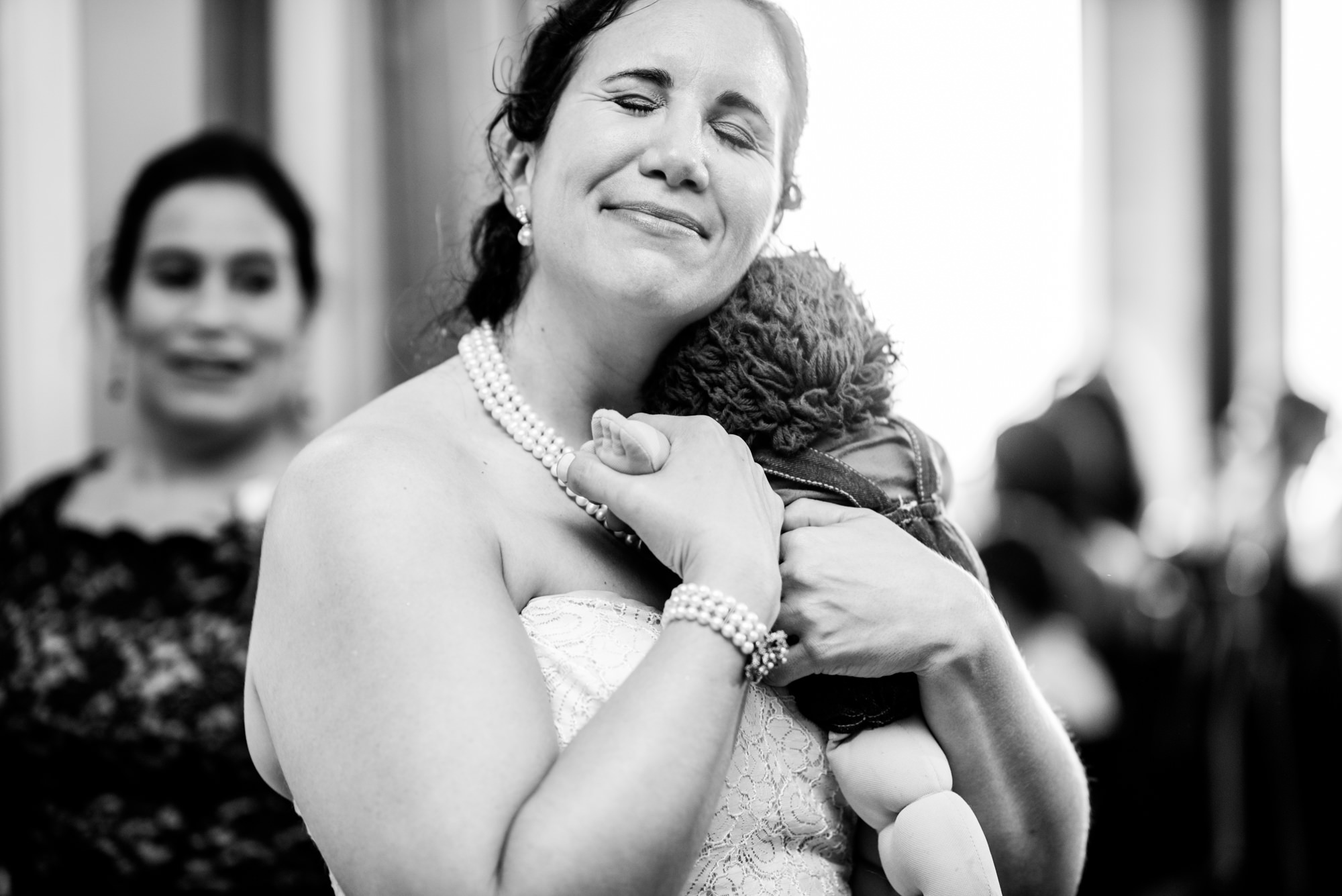 Joelle is given her childhood cuddle toy as a surprise after her siblings' toast, which was mentioned during the performance. Summer 2016. Seattle Tennis Club. Photo by Seattle Wedding Photographers Jennifer Tai Photo Artistry.