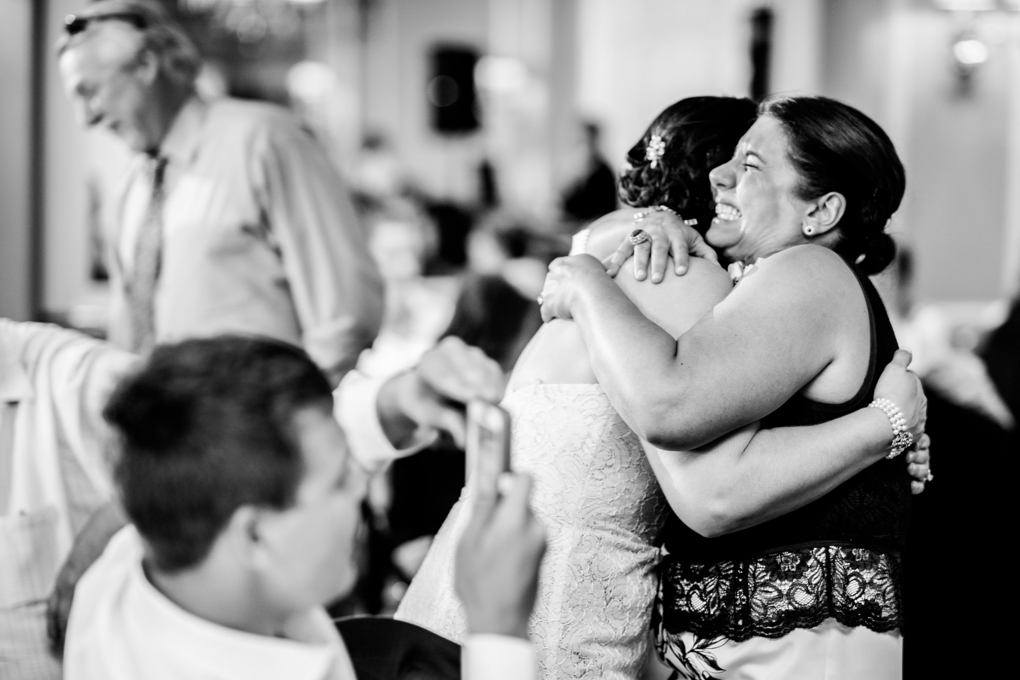 Joelle's sister gives her a hug after her toast. Seattle Tennis Club. Summer 2016. Photo by Seattle Wedding Photographers Jennifer Tai Photo Artistry.
