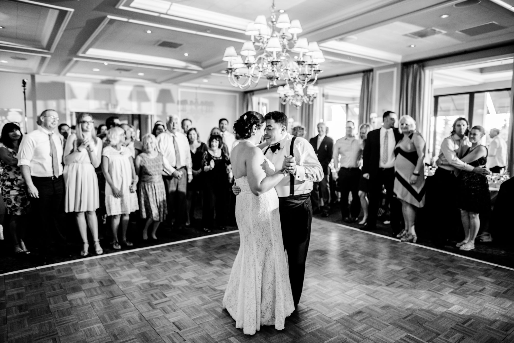 Joelle and Ryan share their first dance at their wedding reception at the Seattle Tennis Club, a wedding venue in Seattle, Washington. Photo by Seattle Wedding Photographers Jennifer Tai Photo Artistry.
