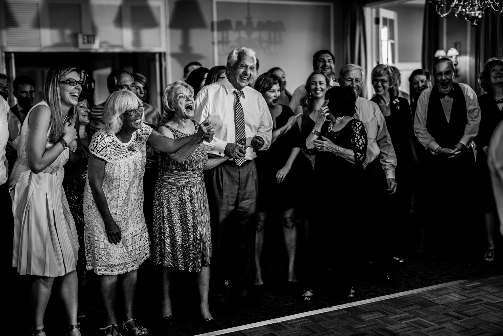 Guests clap and cheer for the longest married couples during the generational dance portion of Joelle and Ryan's wedding reception. Seattle Tennis Club, summer 2016. Photo by Seattle Wedding Photographers Jennifer Tai Photo Artistry.