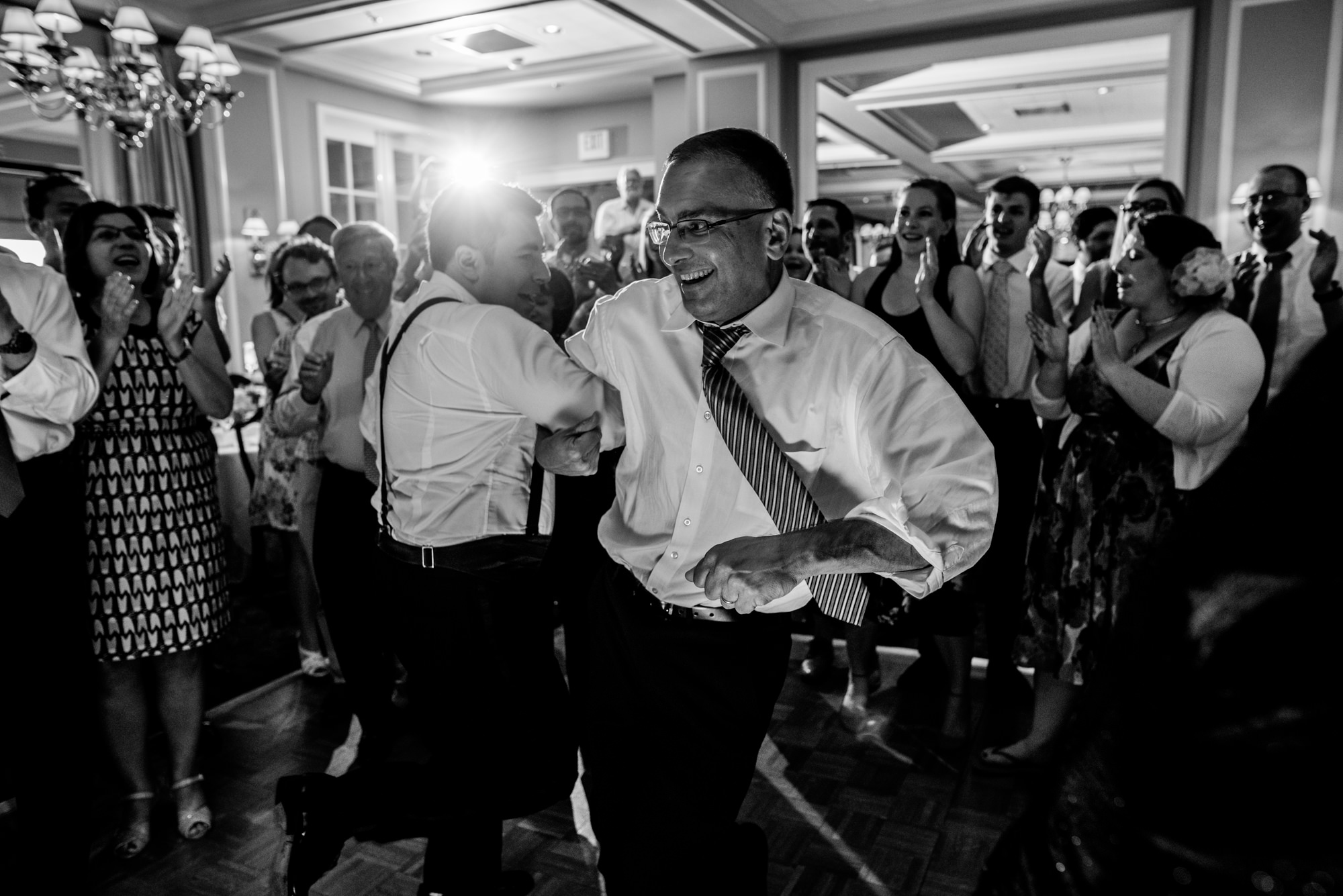 Ryan and Joelle's brother dance the horah at Joelle and Ryan's wedding reception at the Seattle Tennis Club. Summer 2016. Photo by Seattle Wedding Photographers Jennifer Tai Photo Artistry.