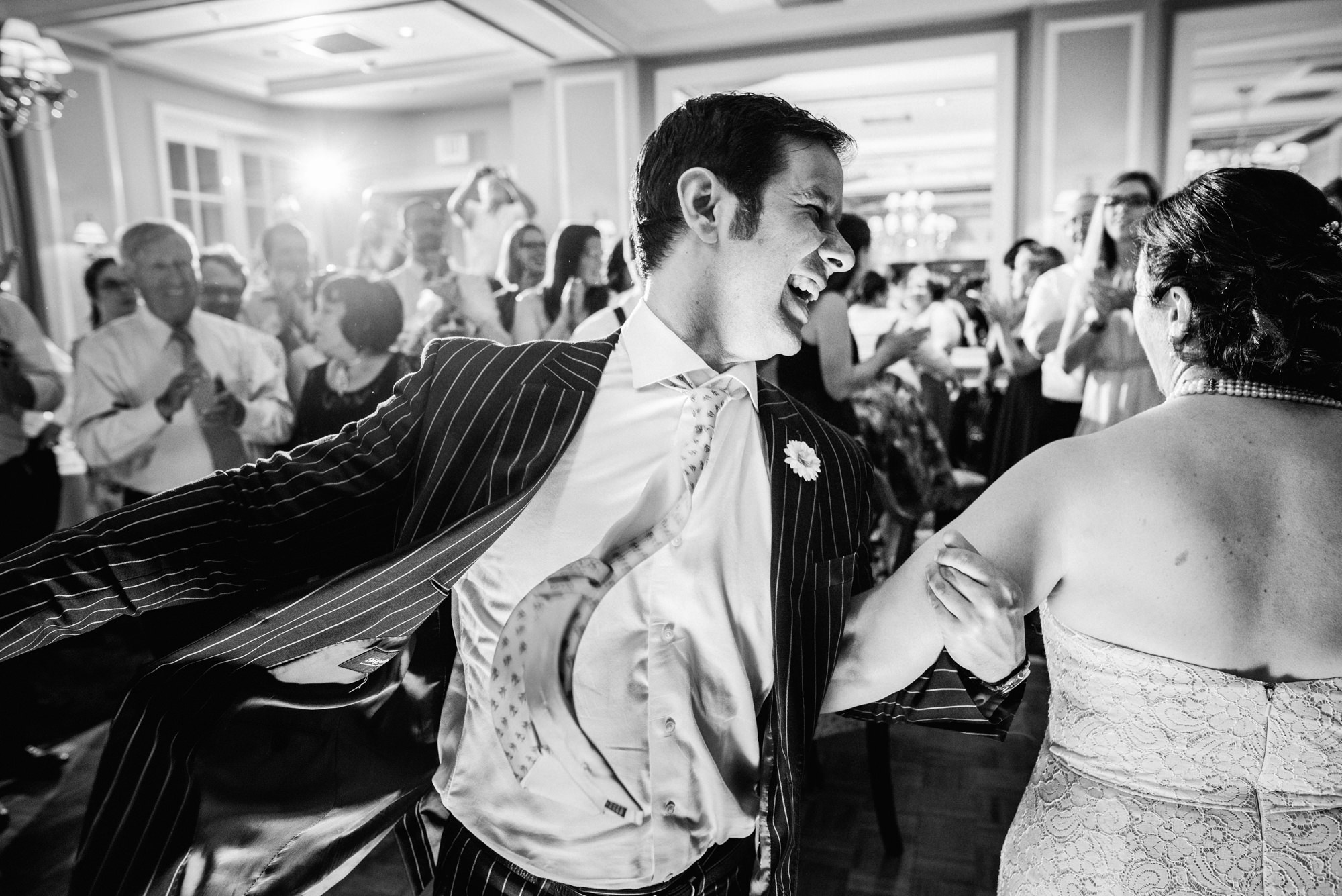 Joelle dances the horah with a cousin at her wedding reception at the Seattle Tennis Club, Summer 2016. Photo by Seattle Wedding Photographers Jennifer Tai Photo Artistry.