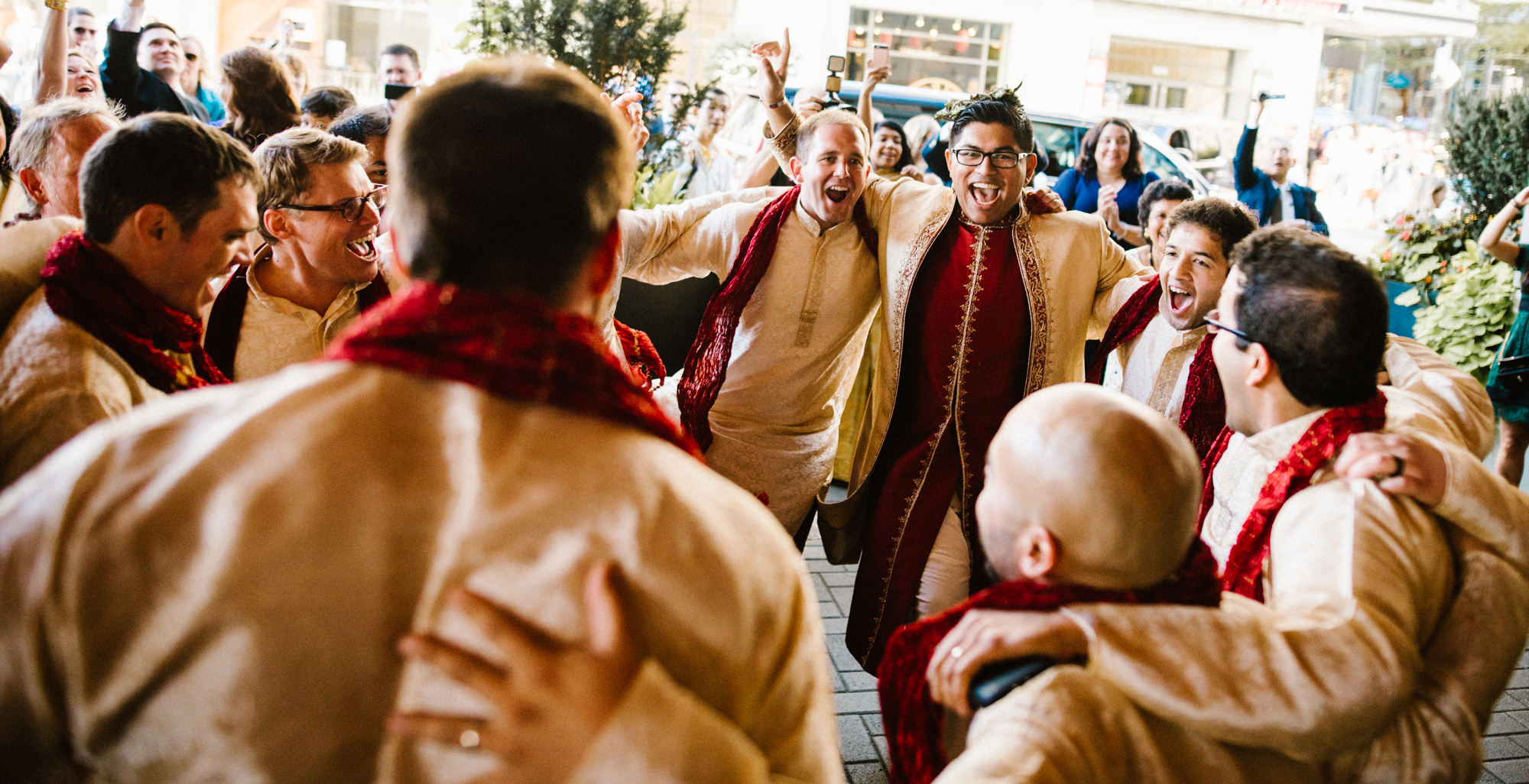 Neel and his groomsmen arrive at his Hindu wedding at the Four Seasons on a rickshaw, dancing bhangra with festive cheers from their guests.
