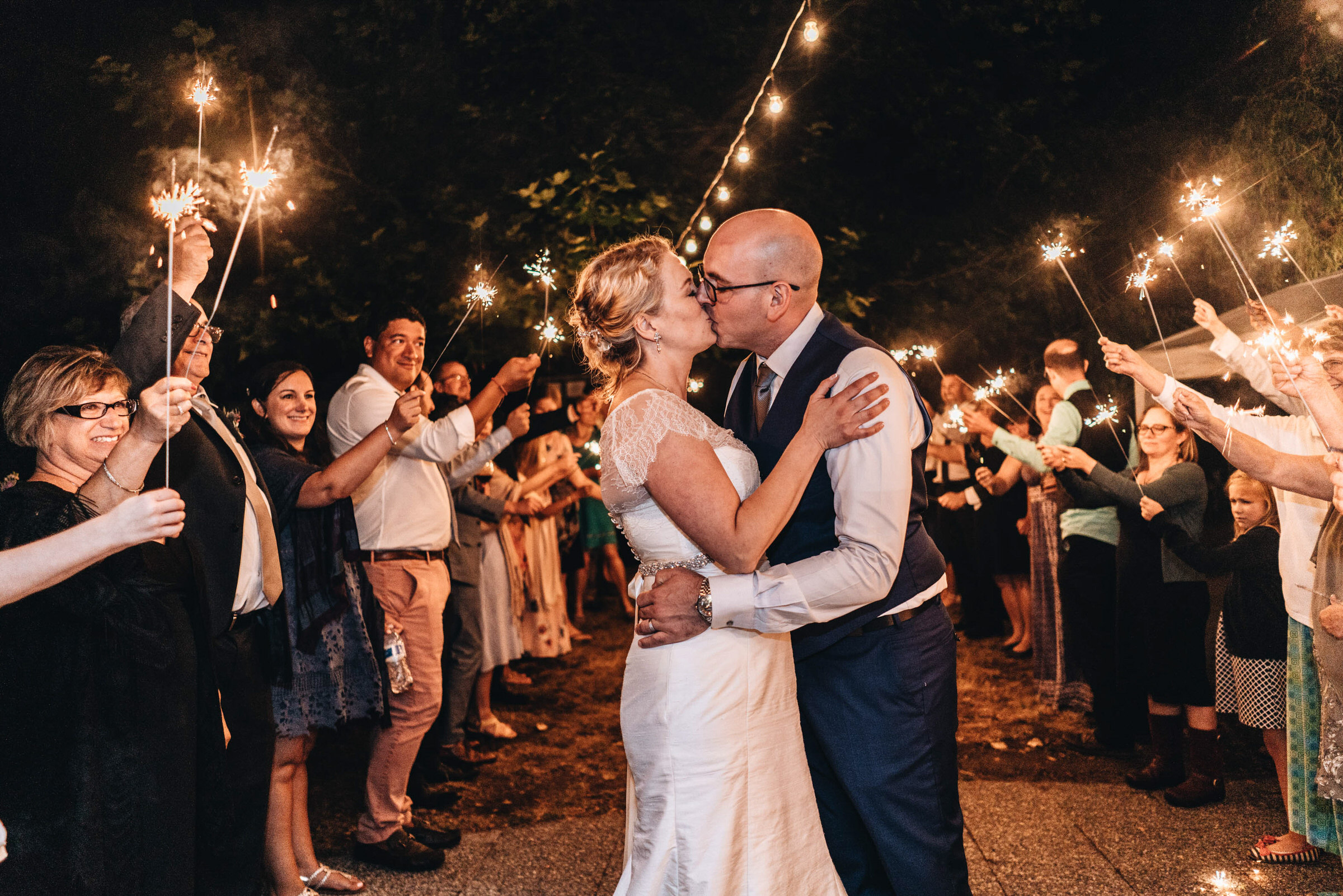 Wayfarer Whidbey Island Wedding: Sara and Joe share a kiss at the end of their night with friends and sparklers!