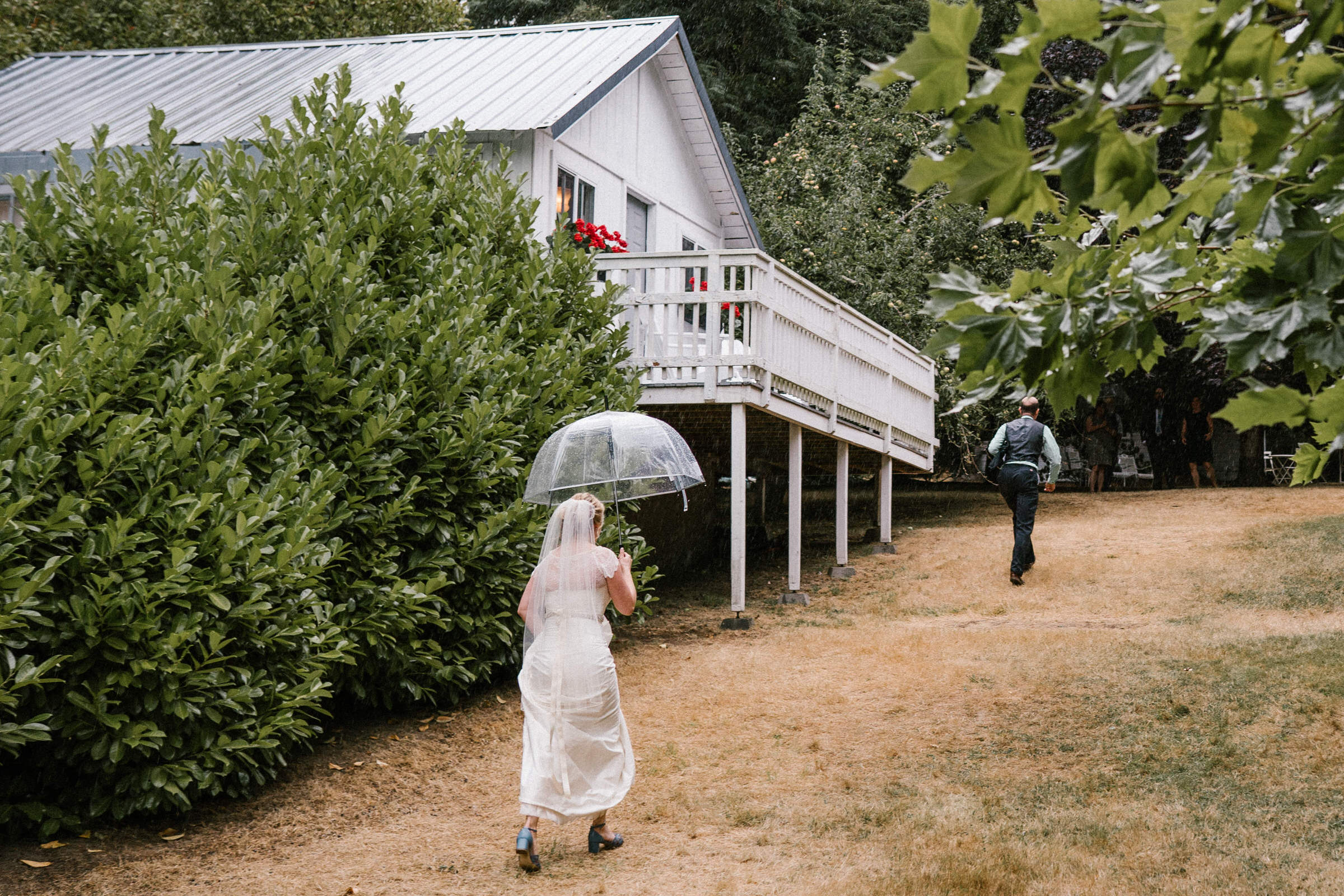 Wayfarer Whidbey Island Wedding: Sara and Joe walk back to their cabin as sprinkles show up but only for a while