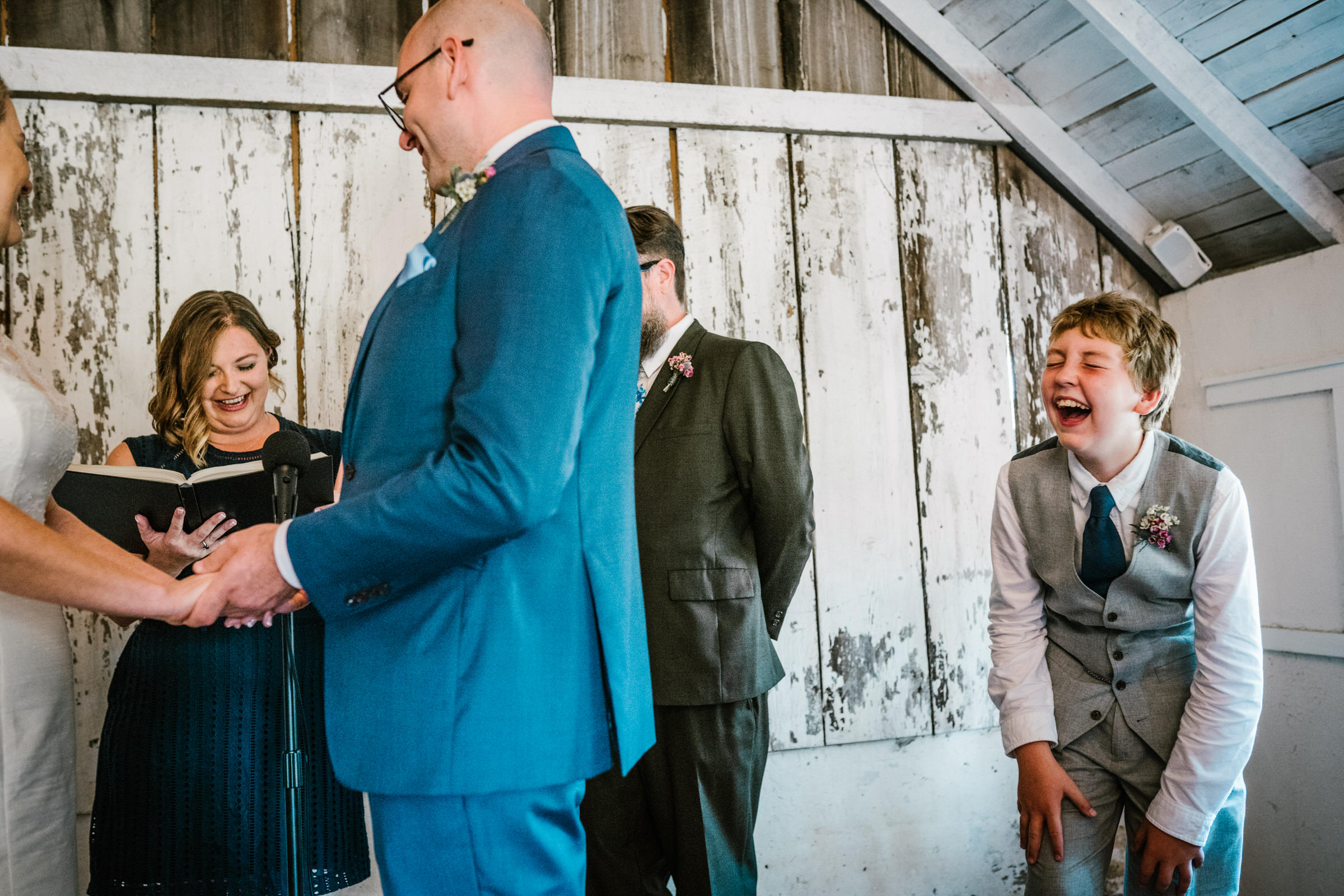 Wayfarer Whidbey Island Wedding: Joe's son giggles at a poem written by Taylor Mali, called "How Falling in Love is like Owning a Dog"