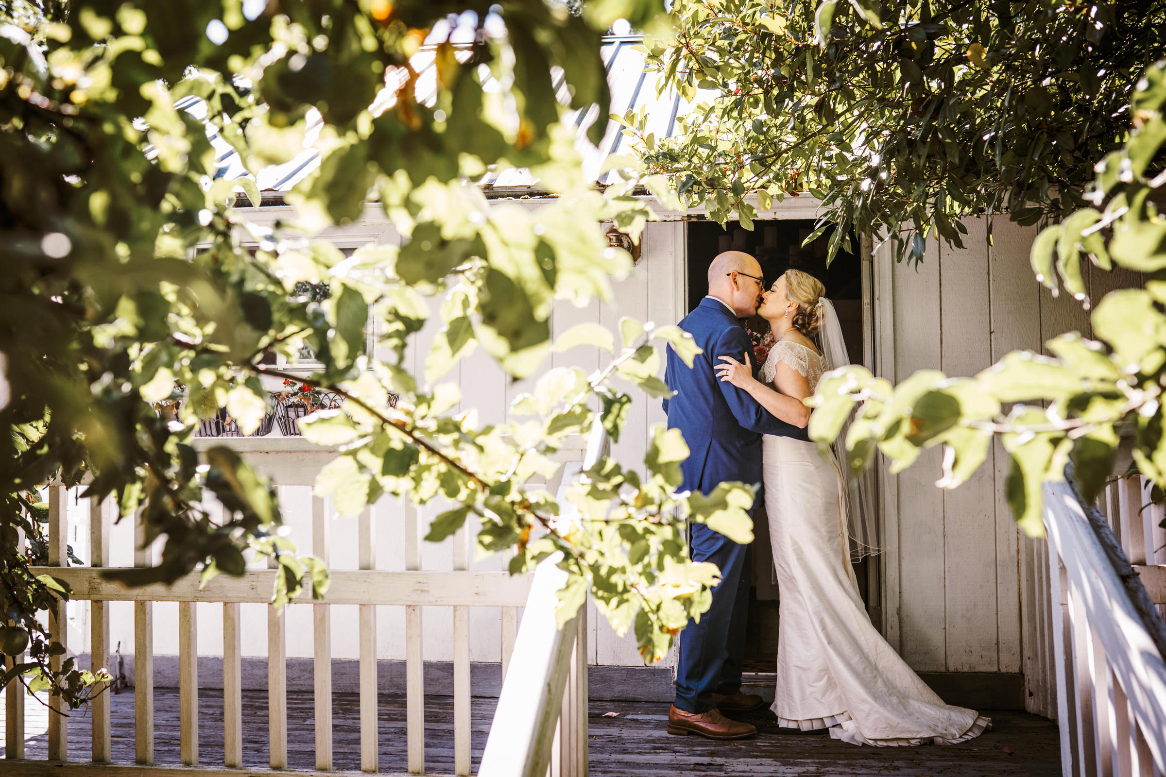 Wayfarer Whidbey Island Wedding: Sara and Joe share a kiss outside the cabin where they sign their papers