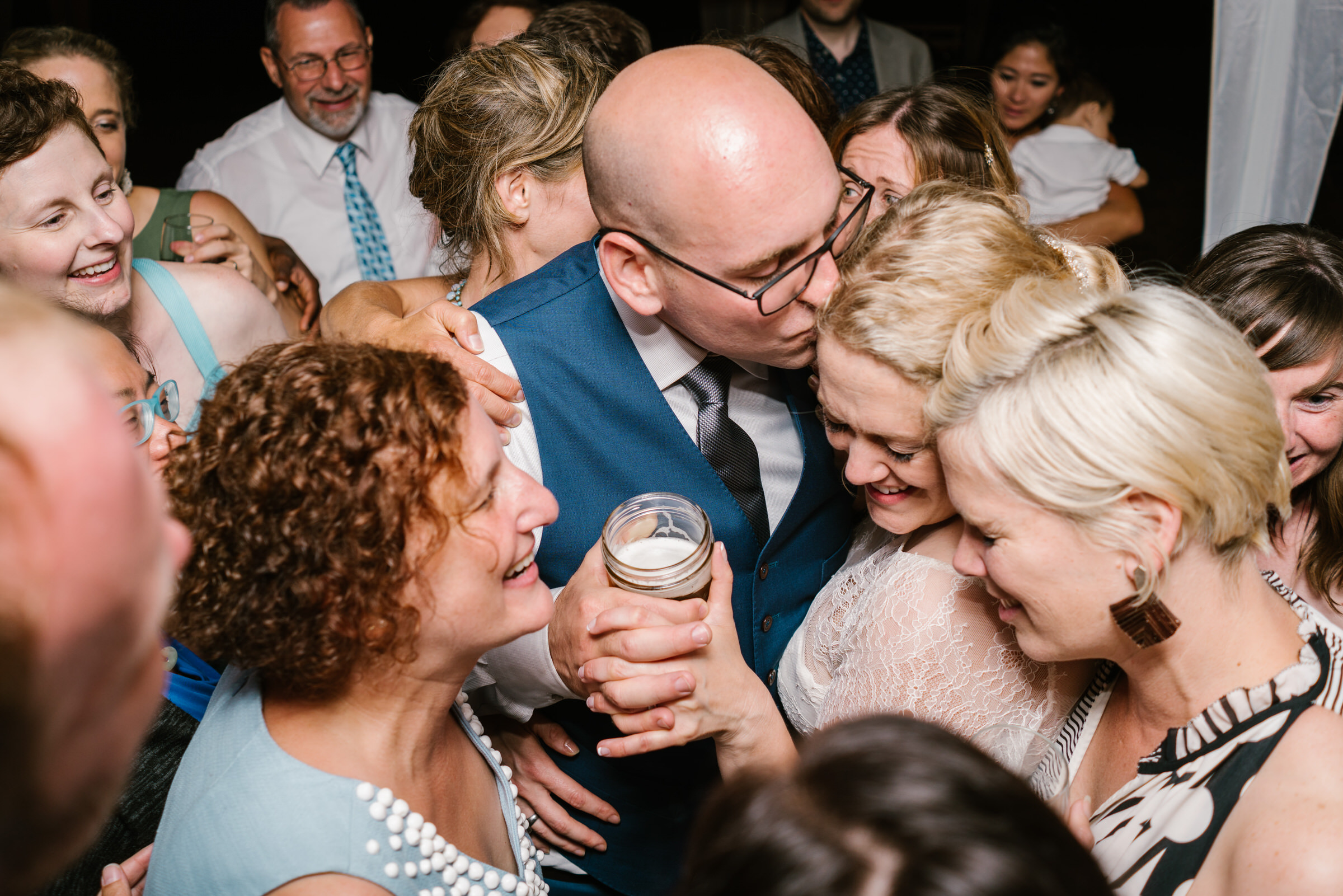 Wayfarer Whidbey Island Wedding: Sara and Joe ad friends share a group hug while dancing