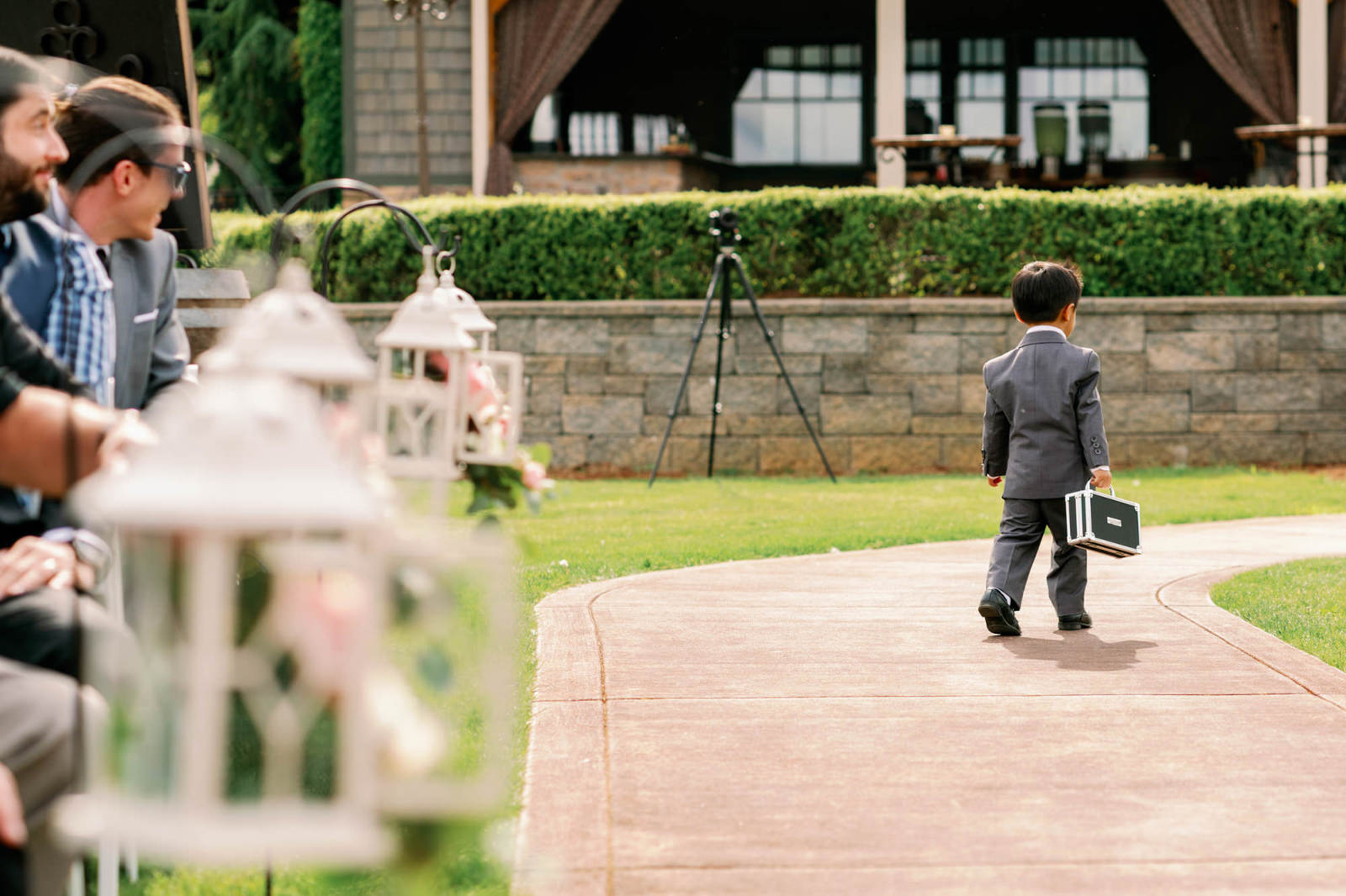 funny moment where ringbearer walks off with rings at Jessica and Brian's wedding at Hidden Meadows