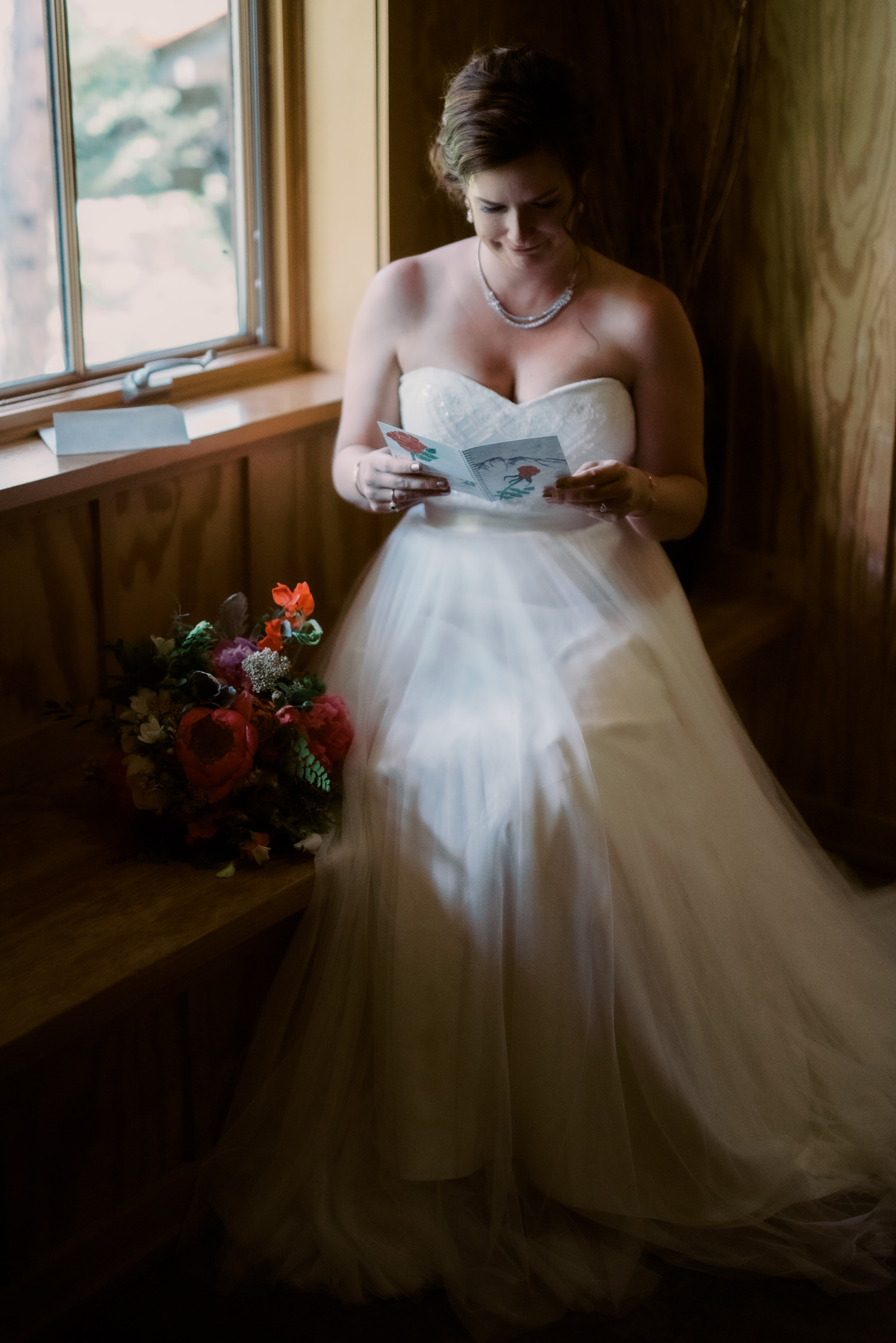 Sleeping Lady Resort weddings: Bride Kristen reads a card from Russ, her groom