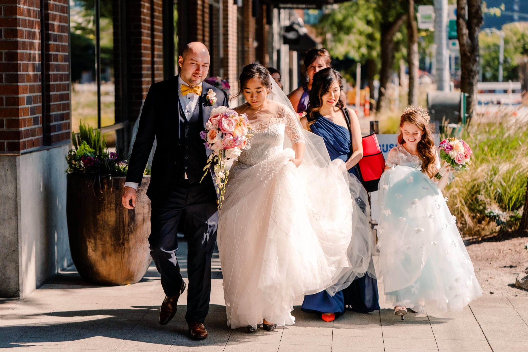 Emma and Joe walk to The Foundry with their wedding party