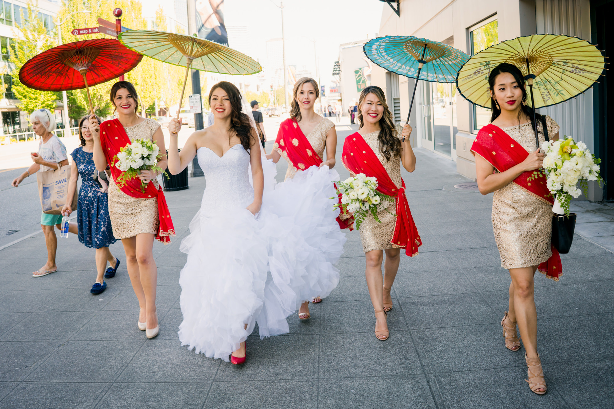 Bride and bridesmaids with modern saree twist with parasols. Photo by Jenn Tai, Seattle Wedding Photographer.