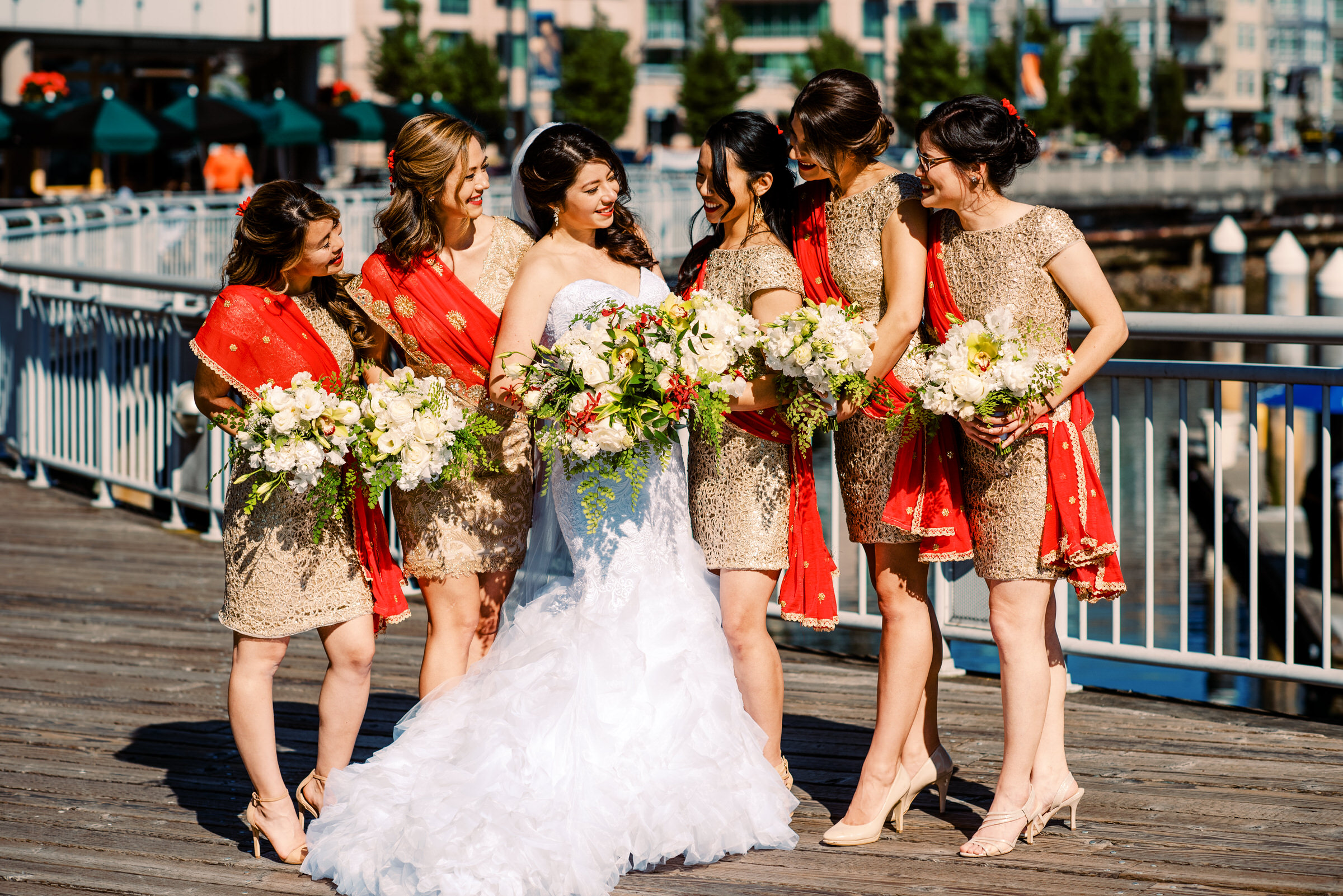 Bride Kelly with her colorful beautiful bridesmaids in red and gold
