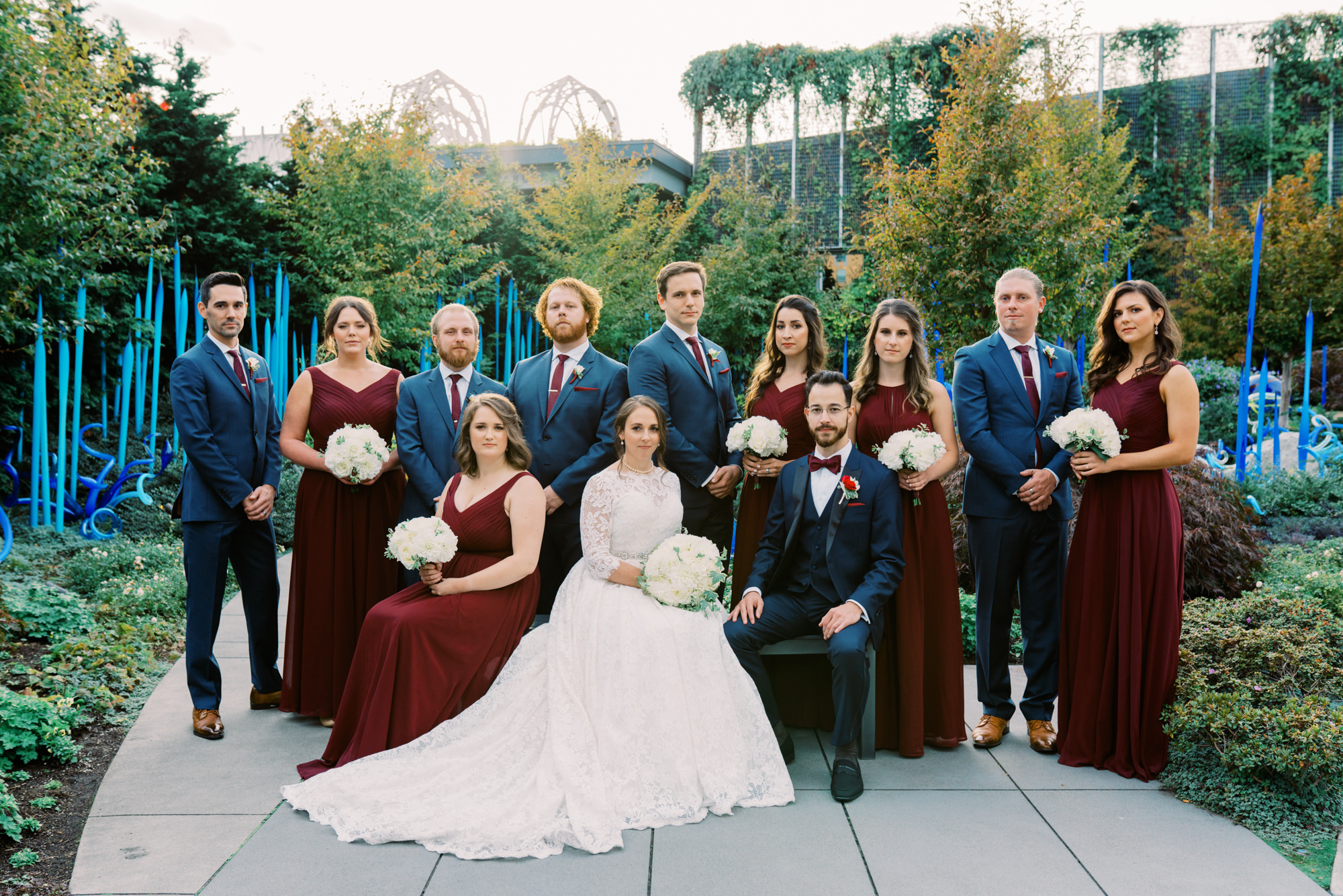 Lauren and Kyle with their wedding party in blue and maroon