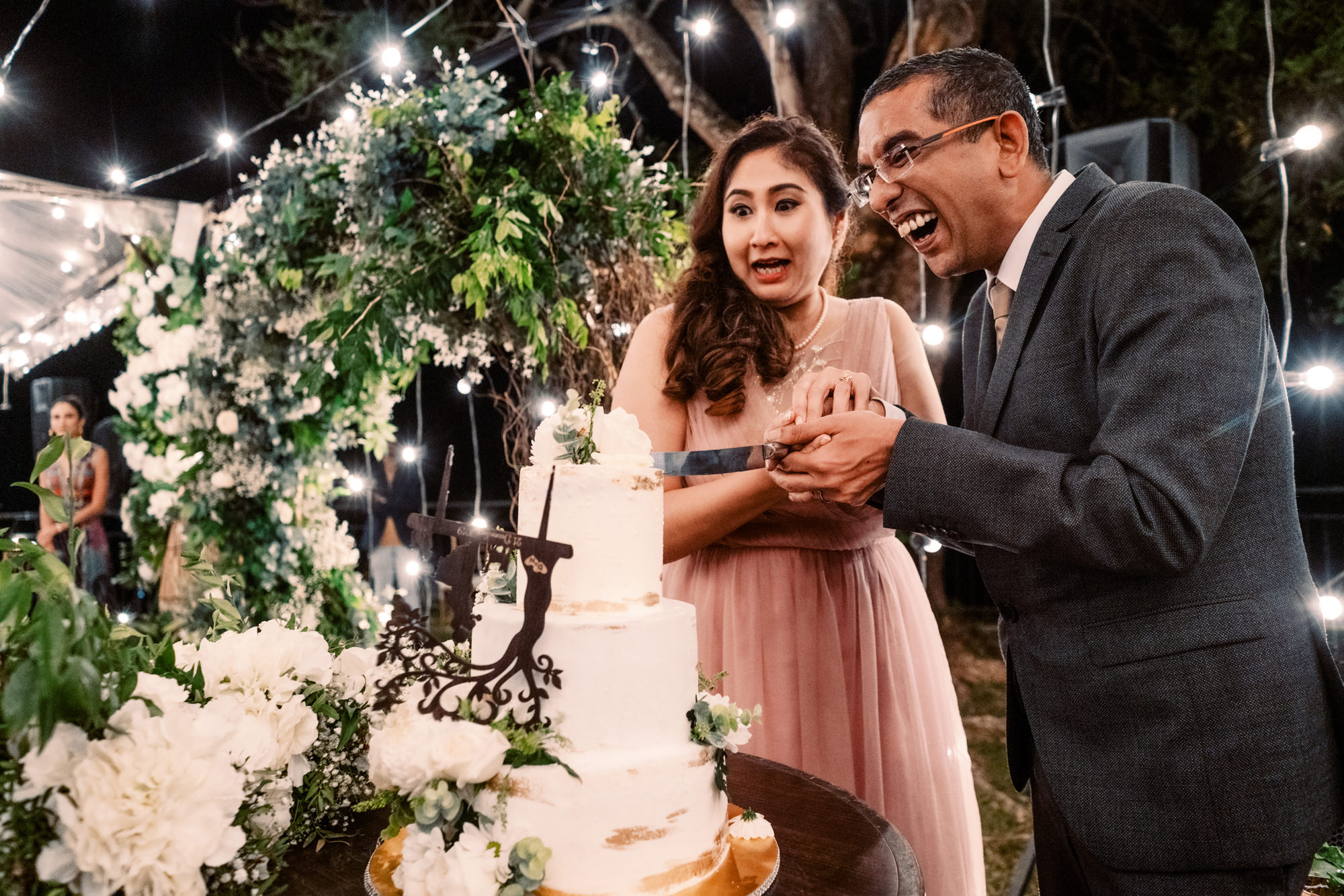 Nadira and Dhillon cut their wedding cake.