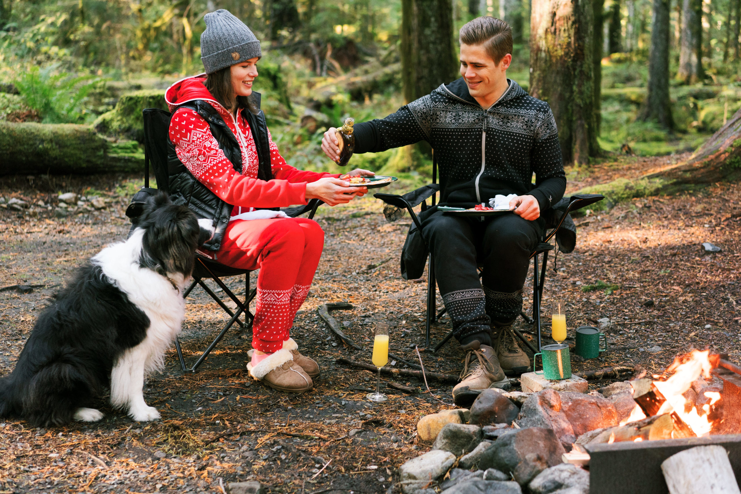 Seattle engagement portraits Veronica and Fletcher eat breakfast by a campfire with their dog