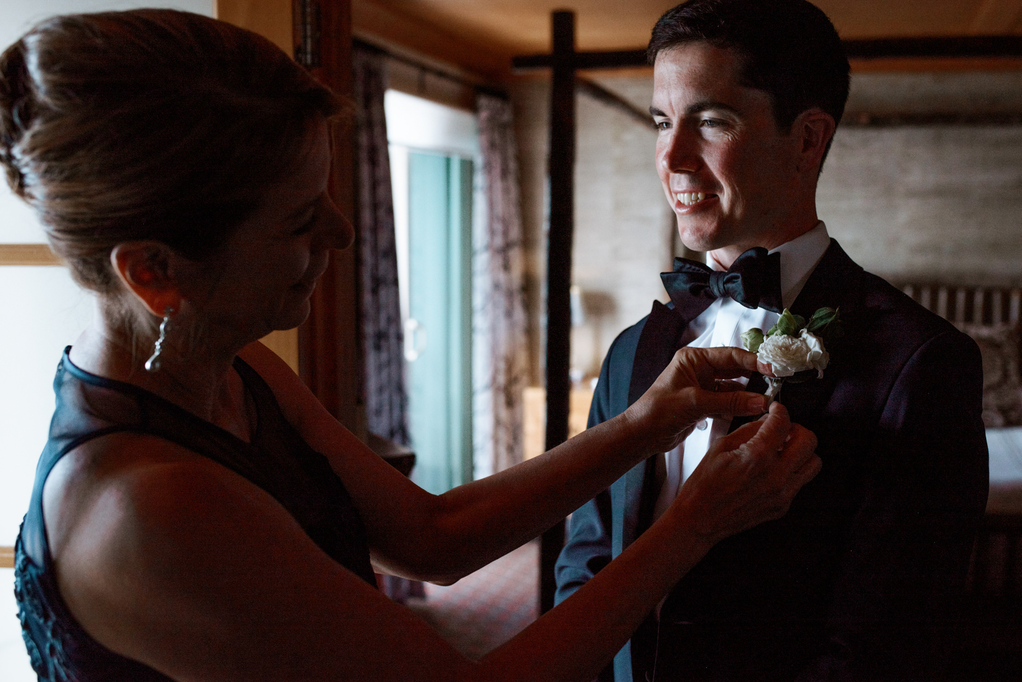 Wedding at the Edgewater Hotel Seattle: Shane's mom puts on his boutonniere