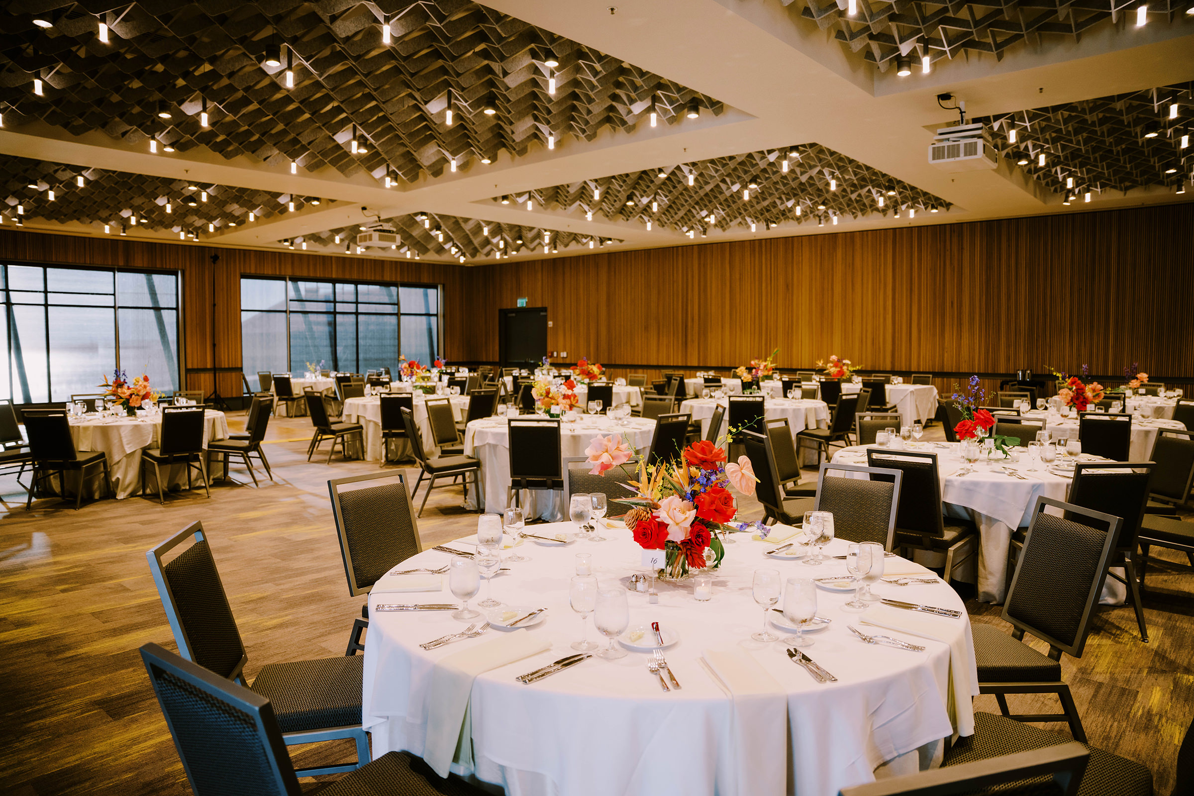 Joey and Dustin's wedding reception at the Bell Harbor Conference Center ballroom, florals by Bahtoh, designed and planned by Emerald Engagements