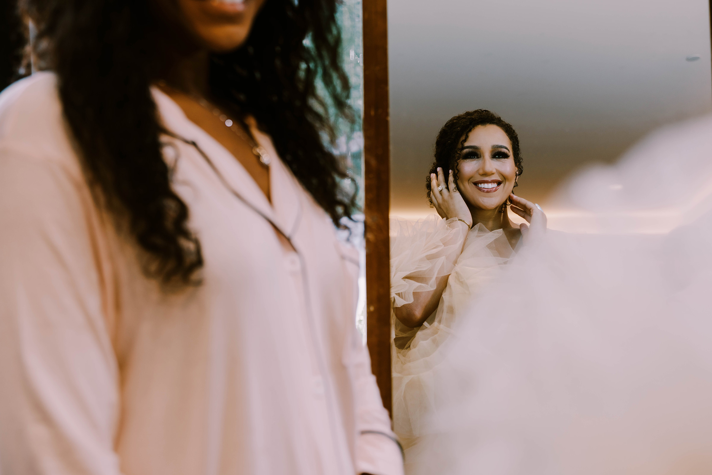 Bride Kasi looking at herself in the mirror during getting ready, Hyatt Regency Lake Washington wedding, summer 2022
